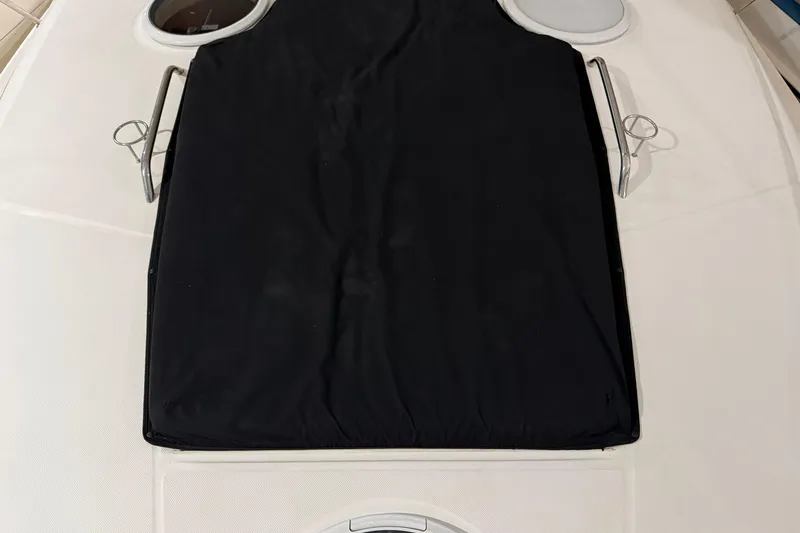 Slide: The Image of 2007 Regal Commodore 3760 IO boat deck with black cover and circular windows. - 38