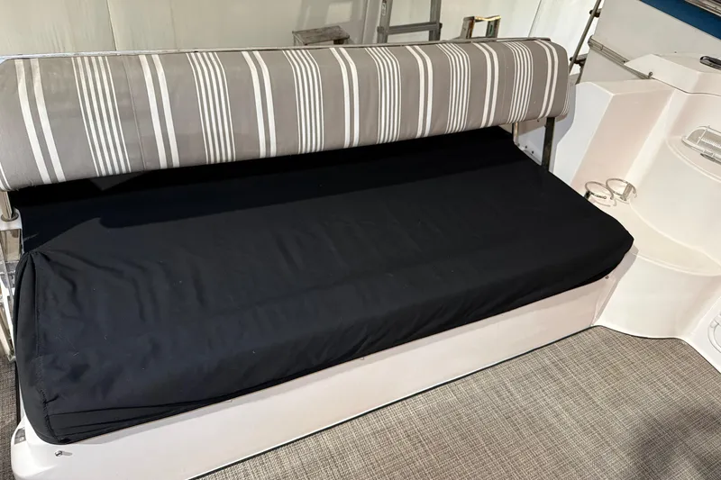 Slide: The Image of 2007 Regal Commodore 3760 IO boat interior with striped seating and black cushion. - 4