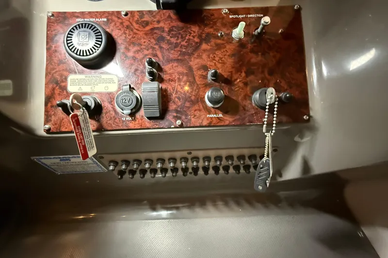 Slide: The Image of Control panel of a 2007 Regal Commodore 3760 IO boat with switches and warning labels. - 9