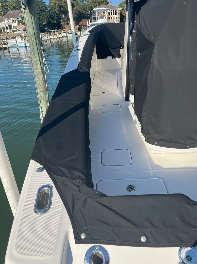 Slide: The Image of 2023 World Cat 280 CC-X boat with black cover at dock. - 19