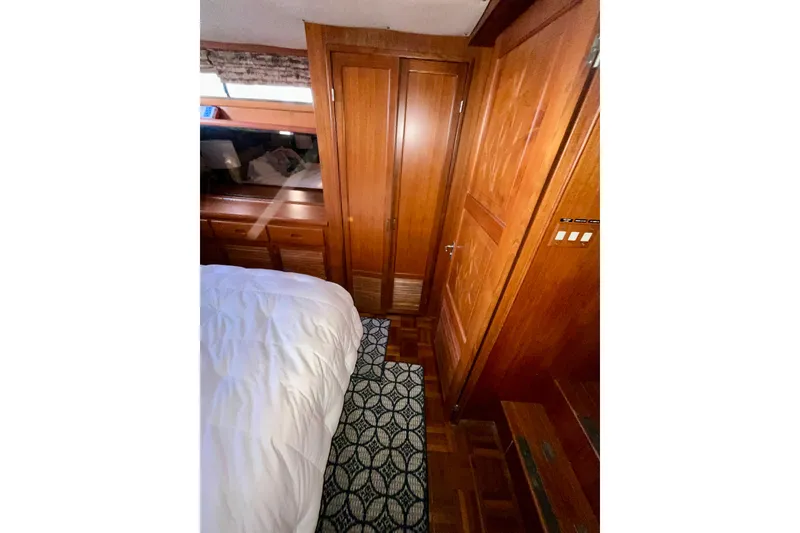 Slide: The Image of Interior of 1987 Lien Hwa 47 Cockpit Motor Yacht with wooden cabinetry and cozy bedding. - 15