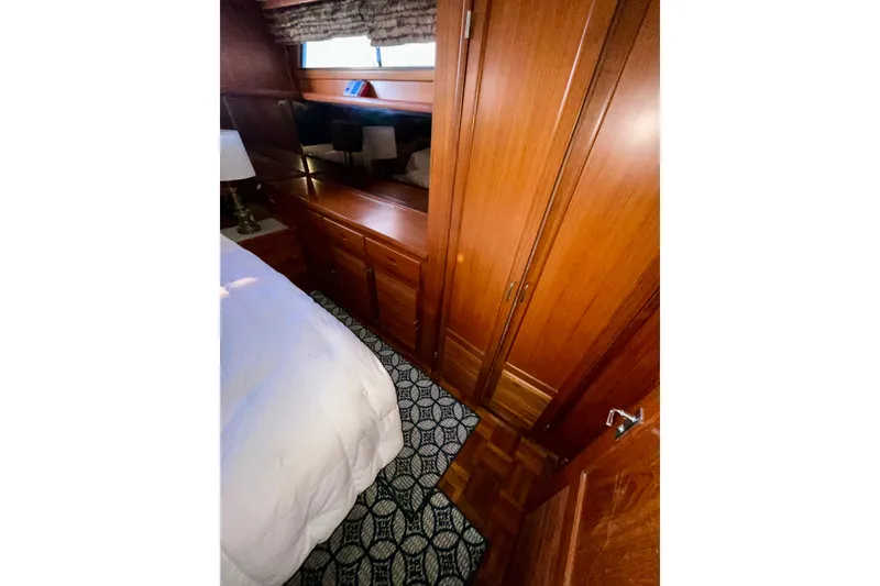 Slide: The Image of 1987 Lien Hwa 47 Cockpit Motor Yacht interior with wood cabinetry and patterned carpet. - 16