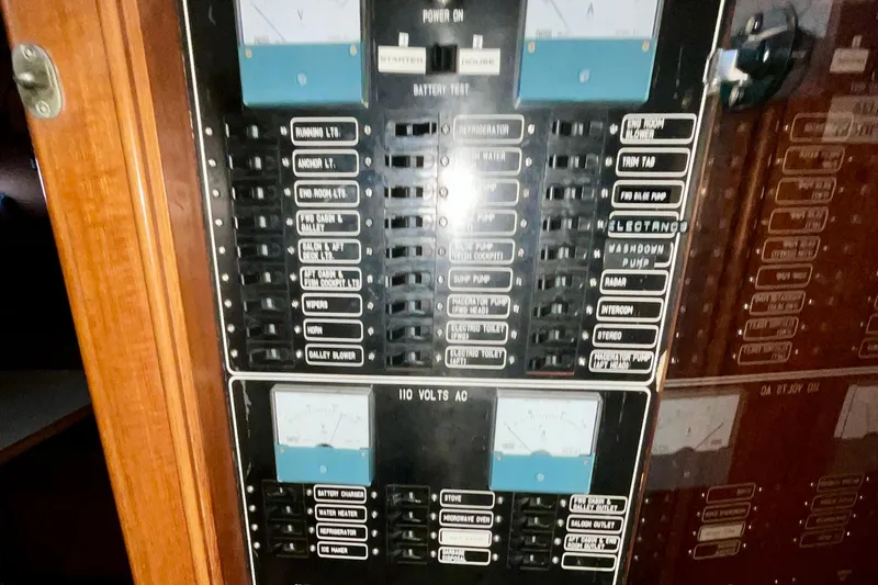 Slide: The Image of Electrical panel of 1987 Lien Hwa 47 Cockpit Motor Yacht, showing various switches and controls. - 19