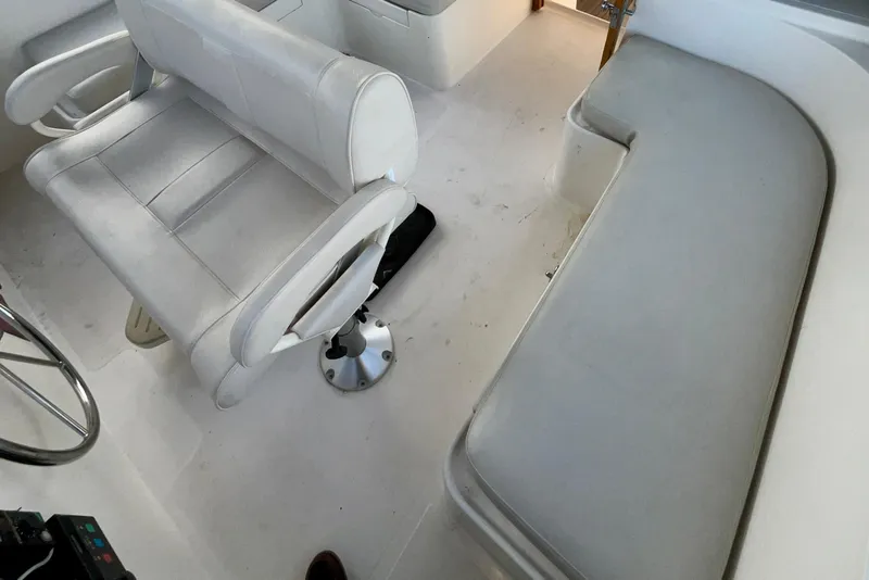 Slide: The Image of 1987 Lien Hwa 47 Cockpit Motor Yacht interior with white seating and helm area. - 23