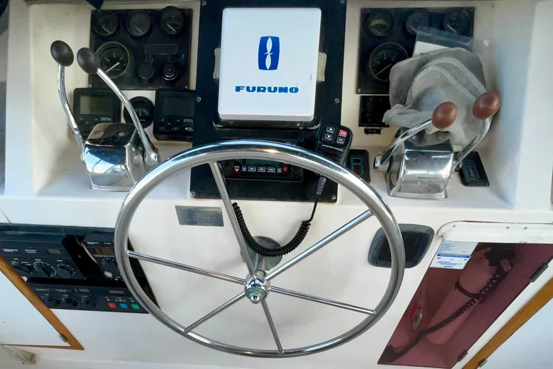 Slide: The Image of 1987 Lien Hwa 47 Cockpit Motor Yacht helm with steering wheel and controls. - 24