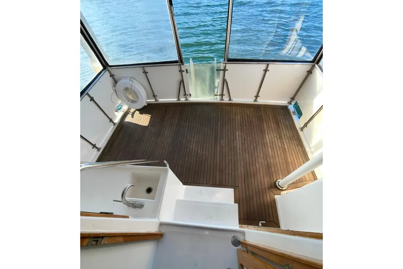 Slide: The Image of 1987 Lien Hwa 47 Cockpit Motor Yacht with wooden deck and ocean view. - 27