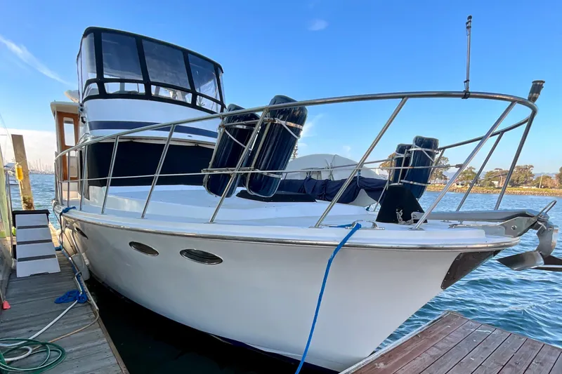 Slide: The Image of 1987 Lien Hwa 47 Cockpit Motor Yacht docked by the water. - 28