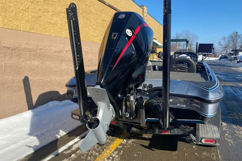 Slide: The Image of 2020 Triton 20 TrX Patriot boat with powerful outboard motor in snowy parking lot. - 6