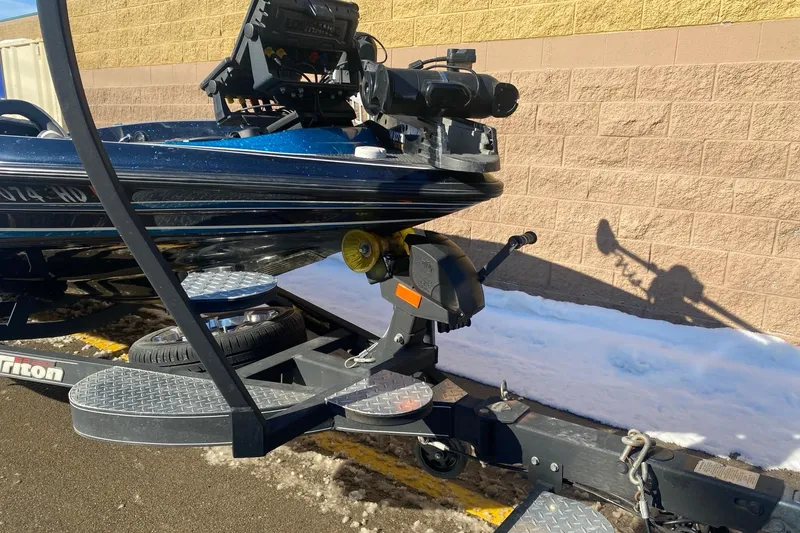 Slide: The Image of 2020 Triton 20 TrX Patriot boat on trailer, parked on snowy pavement. - 8