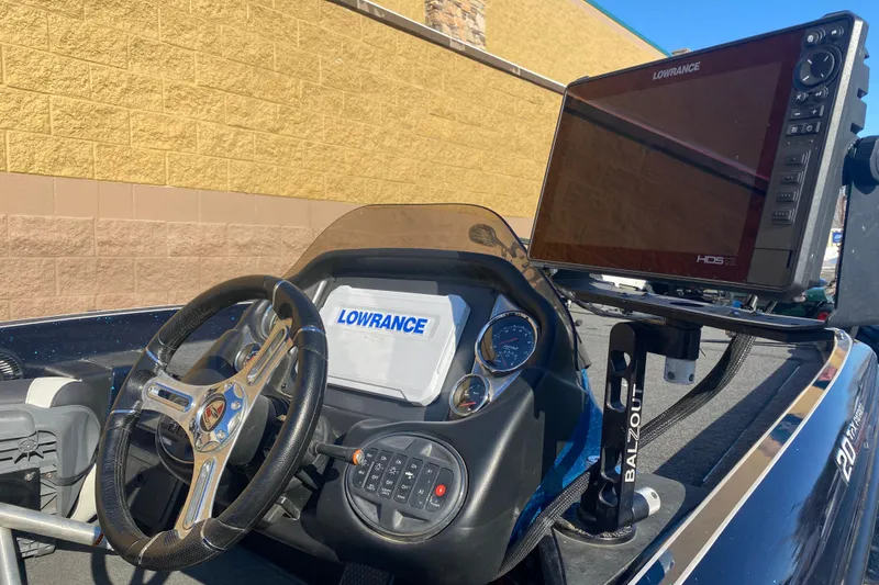 Slide: The Image of 2020 Triton 20 TrX Patriot boat dashboard with Lowrance HDS-12 display and steering wheel. - 9