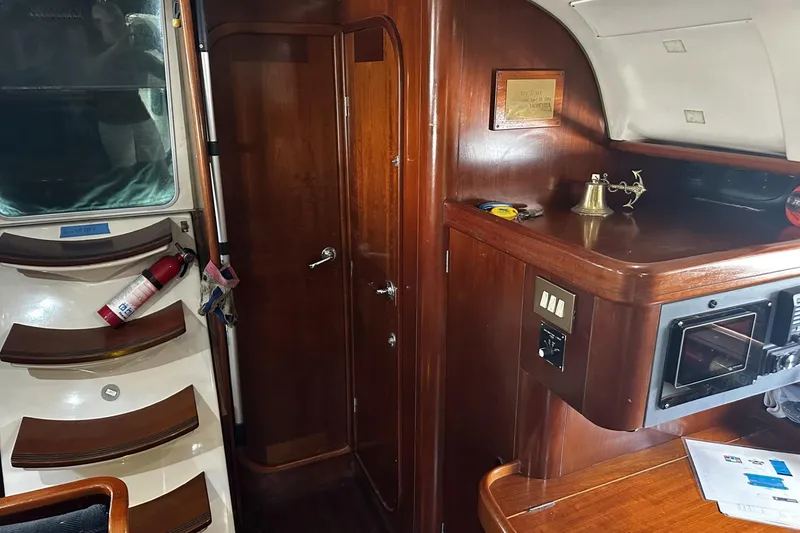 Slide: The Image of Interior of 1994 Beneteau Oceanis 400 yacht with wooden cabinetry and nautical decor. - 15