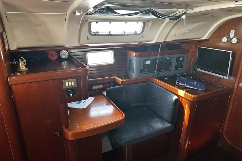 Slide: The Image of Interior of 1994 Beneteau Oceanis 400 yacht with navigation station and seating area. - 18
