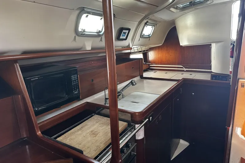 Slide: The Image of Interior of 1994 Beneteau Oceanis 400 yacht kitchen with wood finish and modern appliances. - 20