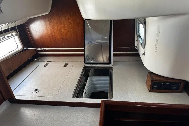Slide: The Image of Interior of 1994 Beneteau Oceanis 400 sailboat, featuring a compact kitchen area. - 25