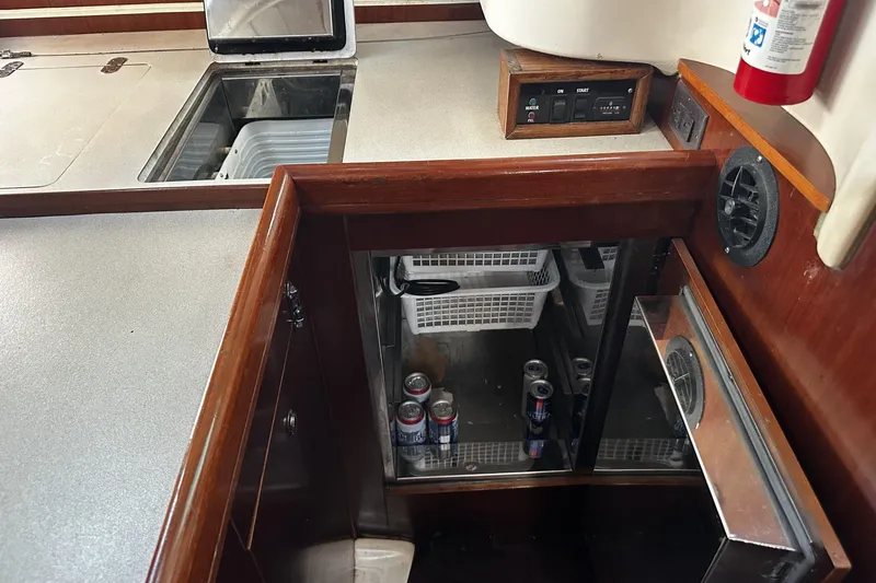 Slide: The Image of Interior of 1994 Beneteau Oceanis 400 yacht kitchen with open fridge and storage. - 26