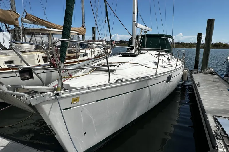 Slide: The Image of 1994 Beneteau Oceanis 400 sailboat docked at marina under clear blue sky. - 3