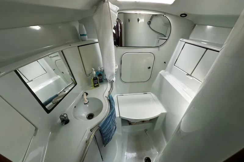 Slide: The Image of Bathroom interior of 1994 Beneteau Oceanis 400 yacht, featuring sink, mirror, and storage. - 31