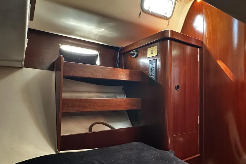 Slide: The Image of Interior cabin of 1994 Beneteau Oceanis 400 yacht with wooden storage and lighting. - 34