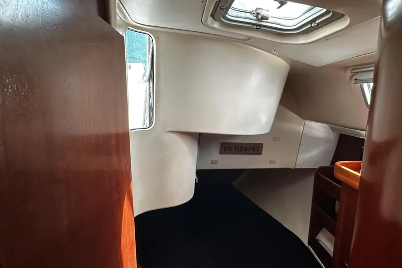 Slide: The Image of Interior of 1994 Beneteau Oceanis 400 sailboat, featuring wood paneling and a skylight. - 35
