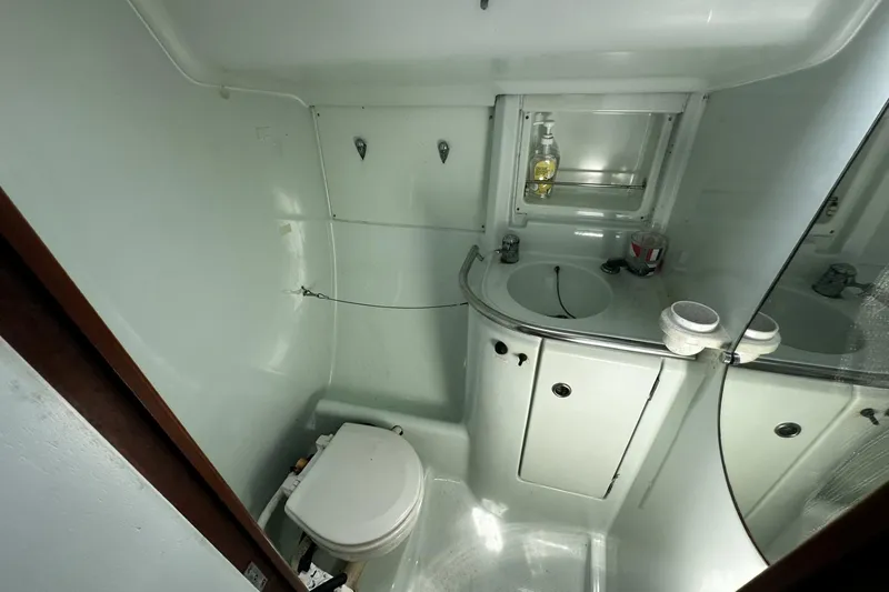 Slide: The Image of Bathroom interior of 1994 Beneteau Oceanis 400 yacht, featuring sink and toilet. - 36
