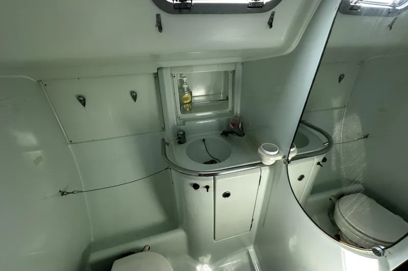 Slide: The Image of Bathroom interior of a 1994 Beneteau Oceanis 400 sailboat, featuring sink and toilet. - 37