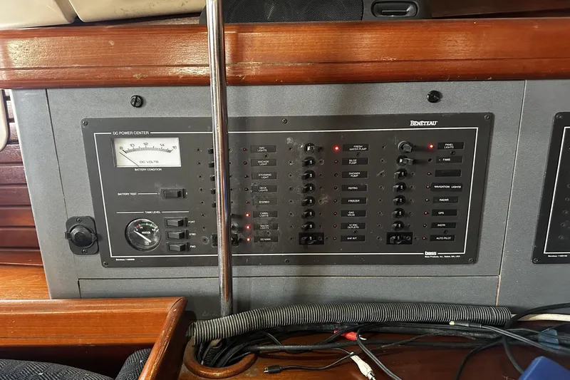Slide: The Image of Control panel of a 1994 Beneteau Oceanis 400 sailboat, featuring various switches and gauges. - 41