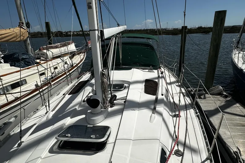 Slide: The Image of Sailboat Beneteau Oceanis 400, 1994 model, docked at marina under clear blue sky. - 43