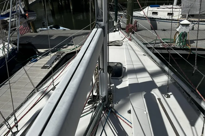 Slide: The Image of Deck view of a 1994 Beneteau Oceanis 400 sailboat docked at a marina. - 47