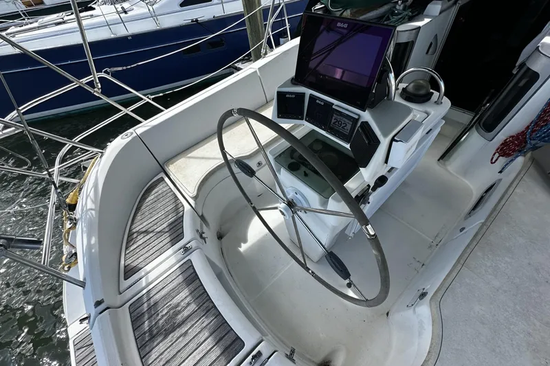 Slide: The Image of Cockpit of 1994 Beneteau Oceanis 400 sailboat with steering wheel and navigation equipment. - 49