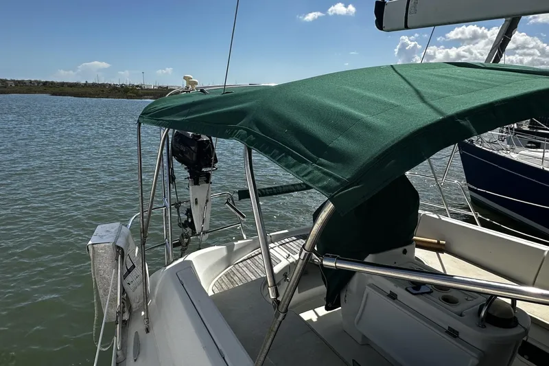 Slide: The Image of Beneteau Oceanis 400 sailboat, 1994 model, with green canopy on calm water. - 7