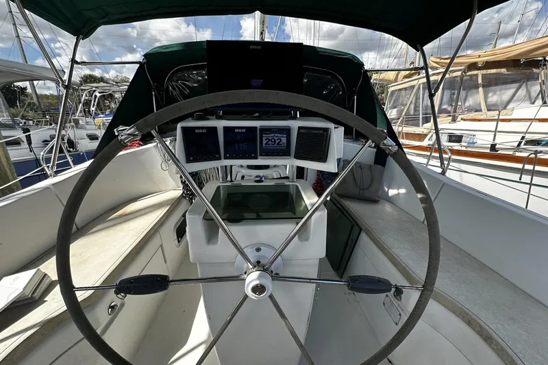 Slide: The Image of Cockpit of 1994 Beneteau Oceanis 400 sailboat with steering wheel and navigation instruments. - 8