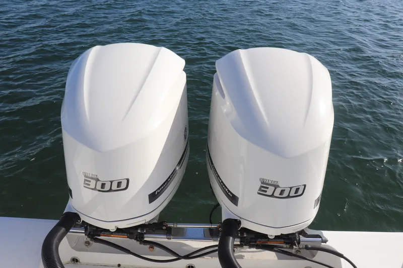 Slide: The Image of Twin Yamaha 300 outboard engines on a 2013 Jupiter 30 boat, floating on water. - 14