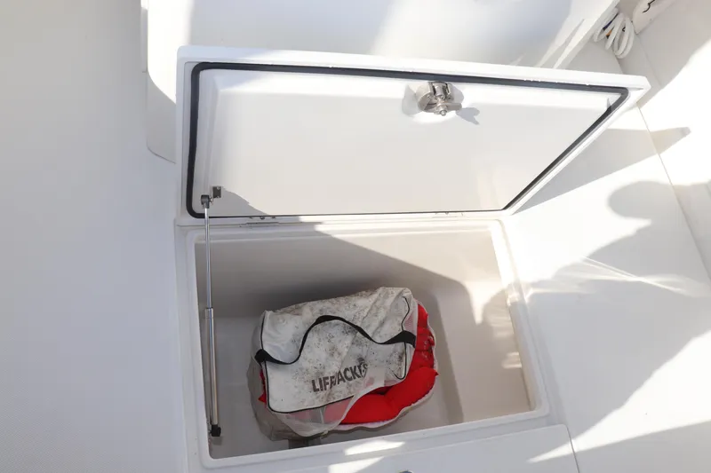 Slide: The Image of Open storage compartment on 2013 Jupiter 30 boat with lifejackets inside. - 15