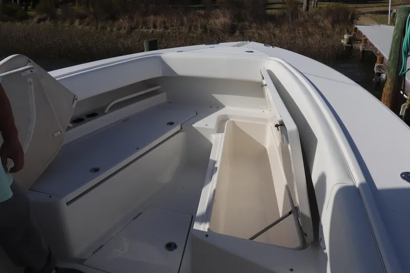 Slide: The Image of 2013 Jupiter 30 boat interior with open storage compartments and seating. - 3