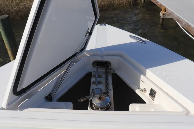 Slide: The Image of Open anchor compartment on 2013 Jupiter 30 boat, showcasing storage and mechanism. - 5