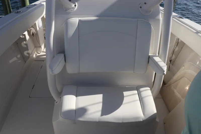 Slide: The Image of White seating on a 2013 Jupiter 30 boat, featuring armrests and marine surroundings. - 8