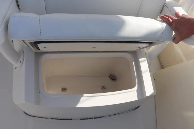 Slide: The Image of Open storage compartment on a 2013 Jupiter 30 boat with white cushioned seat. - 9