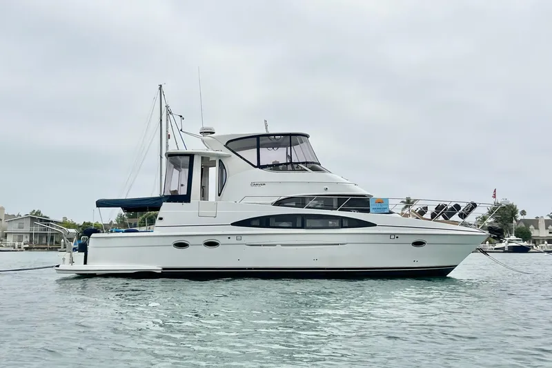 The Image of 2003 Carver 444 Cockpit Motor Yacht on calm water, side view. - 0