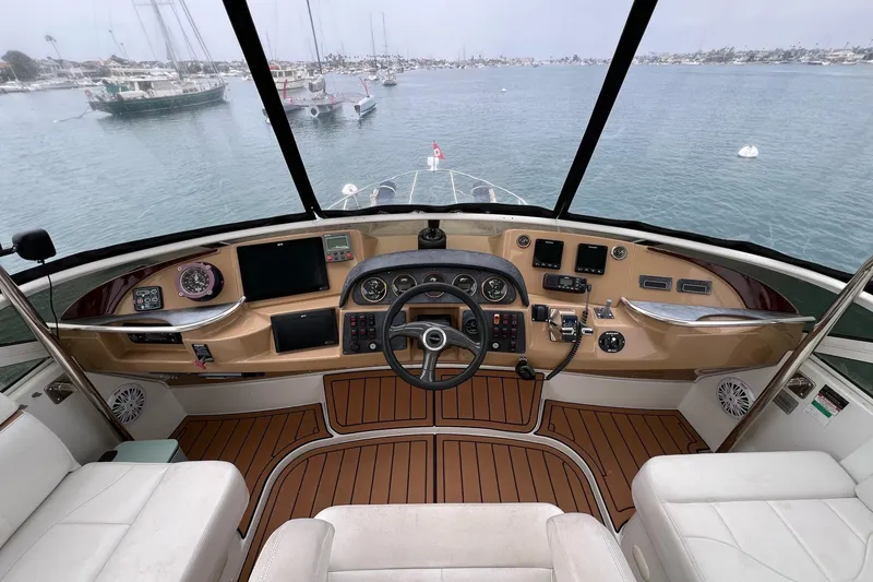 Slide: The Image of 2003 Carver 444 Cockpit Motor Yacht helm with modern controls and panoramic water view. - 15