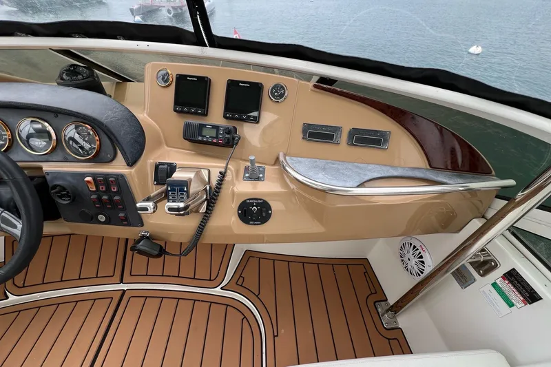 Slide: The Image of 2003 Carver 444 Cockpit Motor Yacht helm with navigation instruments and controls. - 17