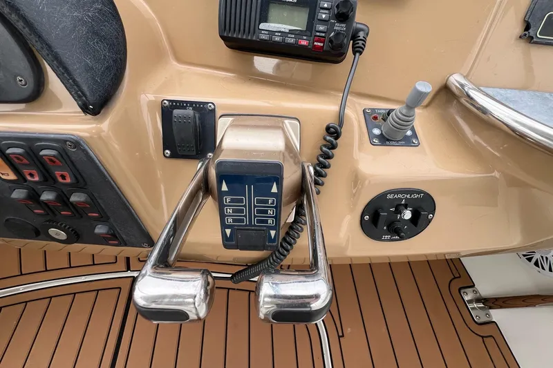 Slide: The Image of Control panel of a 2003 Carver 444 Cockpit Motor Yacht with throttle and navigation controls. - 18