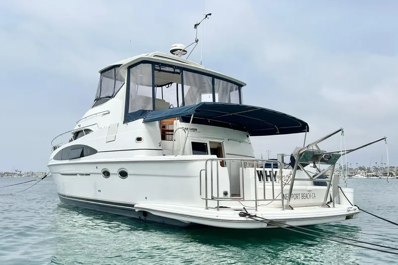 Slide: The Image of 2003 Carver 444 Cockpit Motor Yacht anchored in calm waters, Newport Beach. - 2