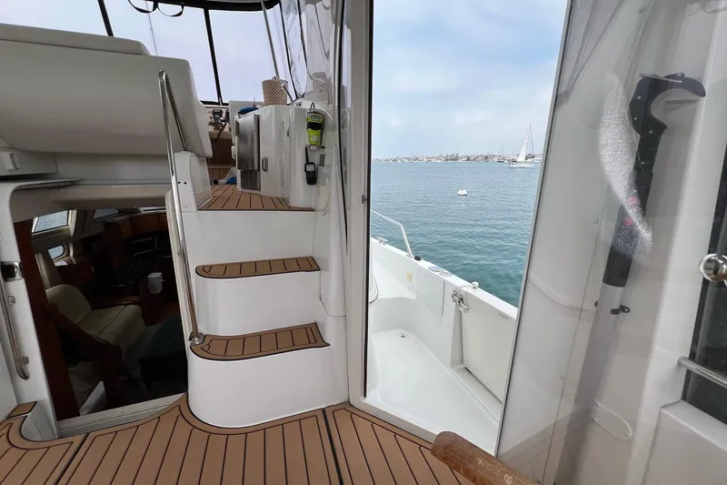 Slide: The Image of 2003 Carver 444 Cockpit Motor Yacht interior with stairs and ocean view. - 24