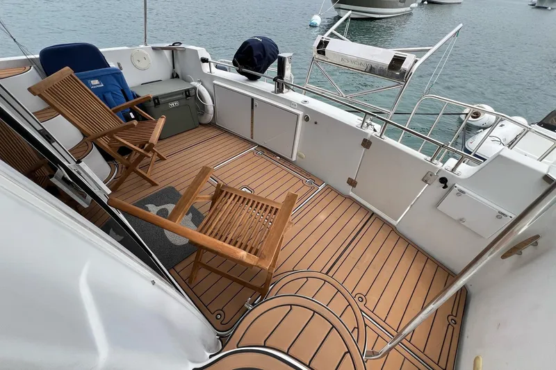 Slide: The Image of 2003 Carver 444 Cockpit Motor Yacht with wooden deck chairs on a spacious cockpit. - 34