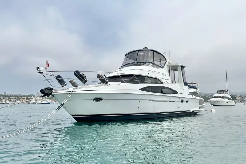 Slide: The Image of 2003 Carver 444 Cockpit Motor Yacht anchored in calm waters. - 4