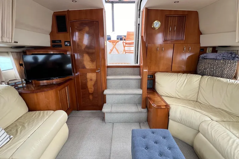 Slide: The Image of Interior of 2003 Carver 444 Cockpit Motor Yacht with leather seating and wooden cabinetry. - 45