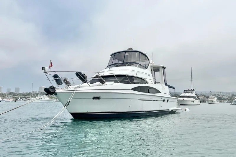 Slide: The Image of 2003 Carver 444 Cockpit Motor Yacht anchored in a serene harbor setting. - 5