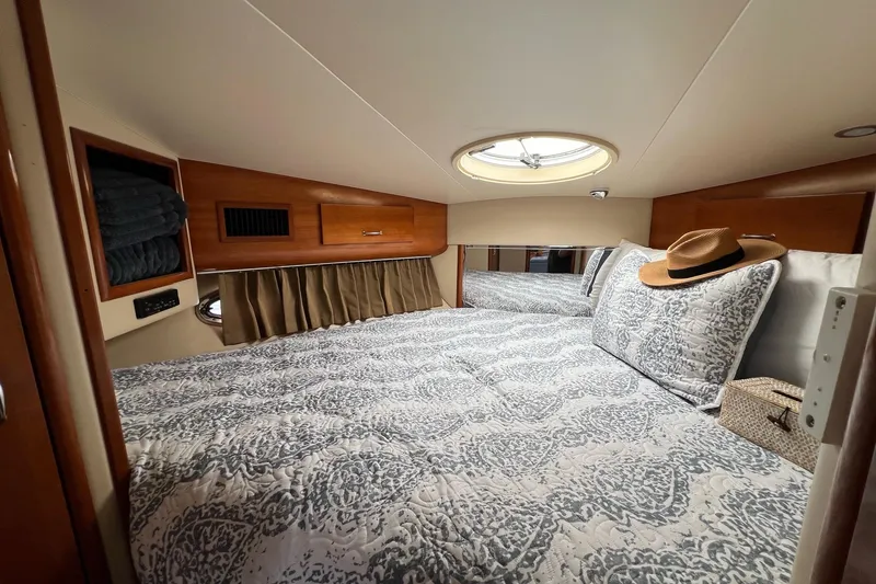 Slide: The Image of Luxurious 2003 Carver 444 Cockpit Motor Yacht bedroom with elegant bedding and natural light. - 51