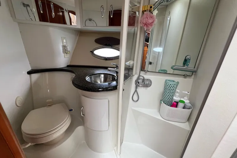 Slide: The Image of 2003 Carver 444 Cockpit Motor Yacht bathroom with sink, toilet, and shower amenities. - 53