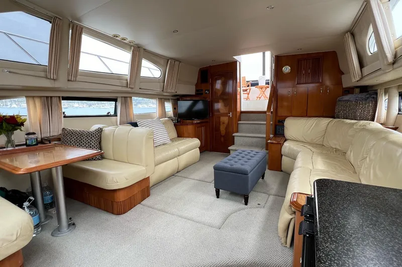 Slide: The Image of Luxurious interior of 2003 Carver 444 Cockpit Motor Yacht with plush seating and elegant decor. - 54